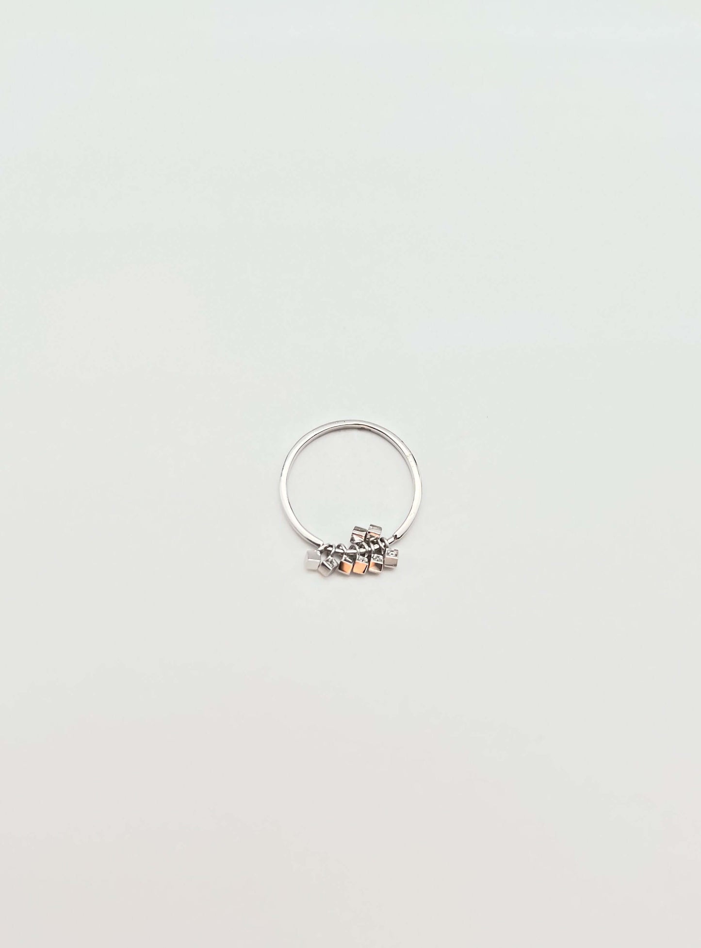 Elara sterling silver ring with hanging cube motif with zircon