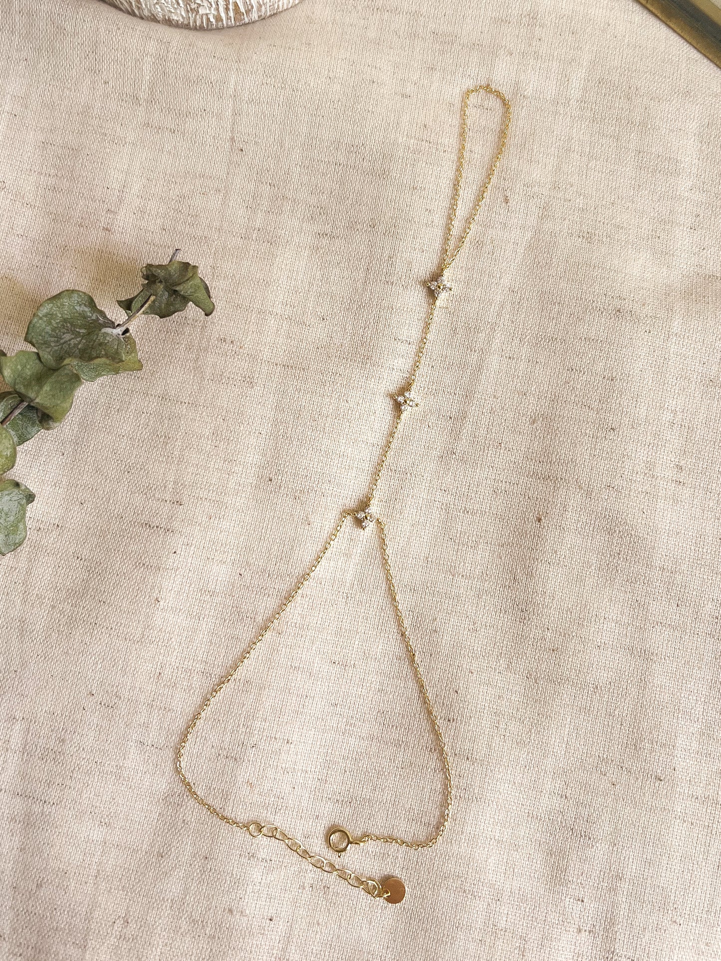 Tristar 18k gold plated hand chain with studded zircon in sterling silver