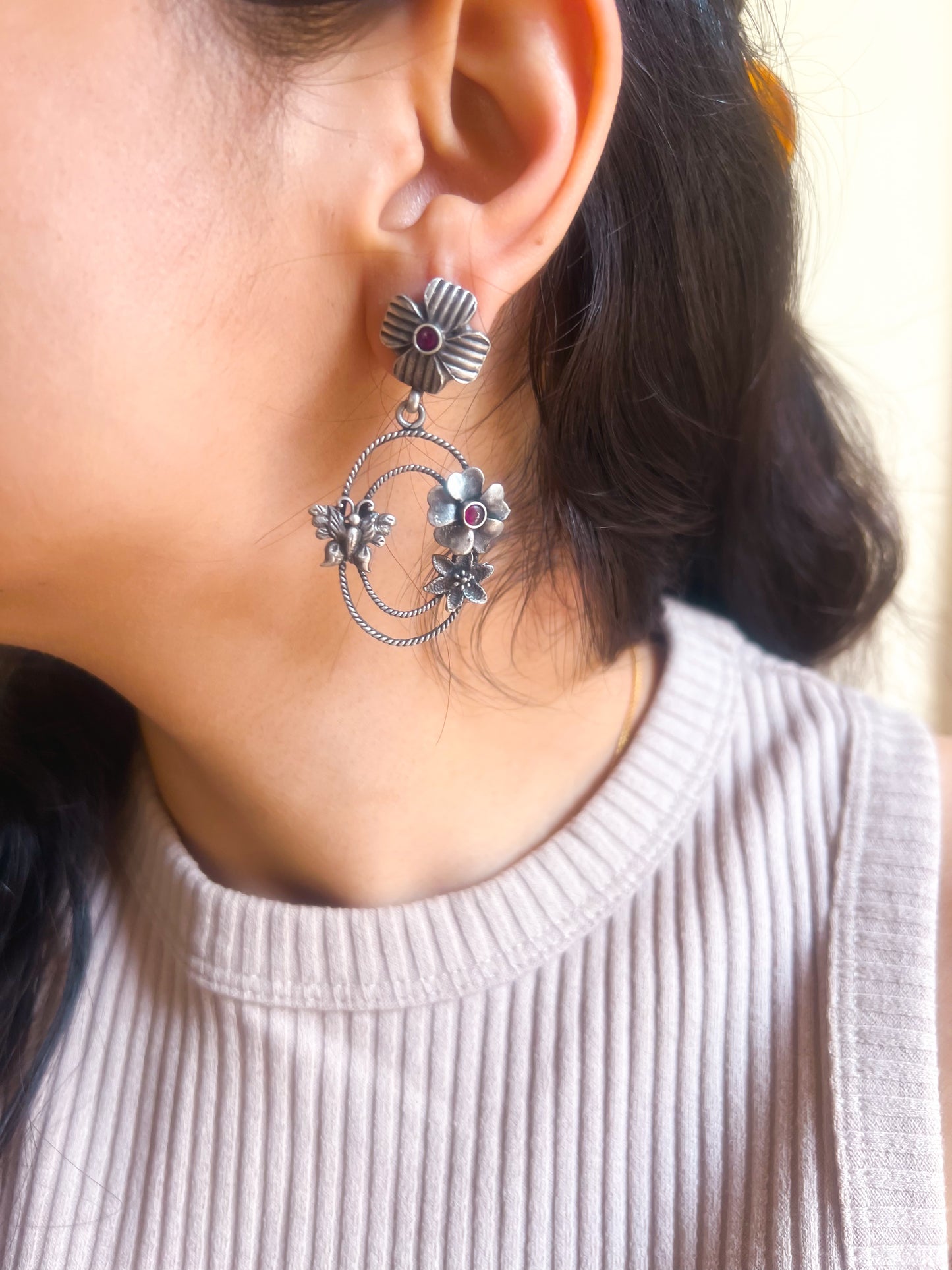Prakruti silver earring with flower motif and ruby stone