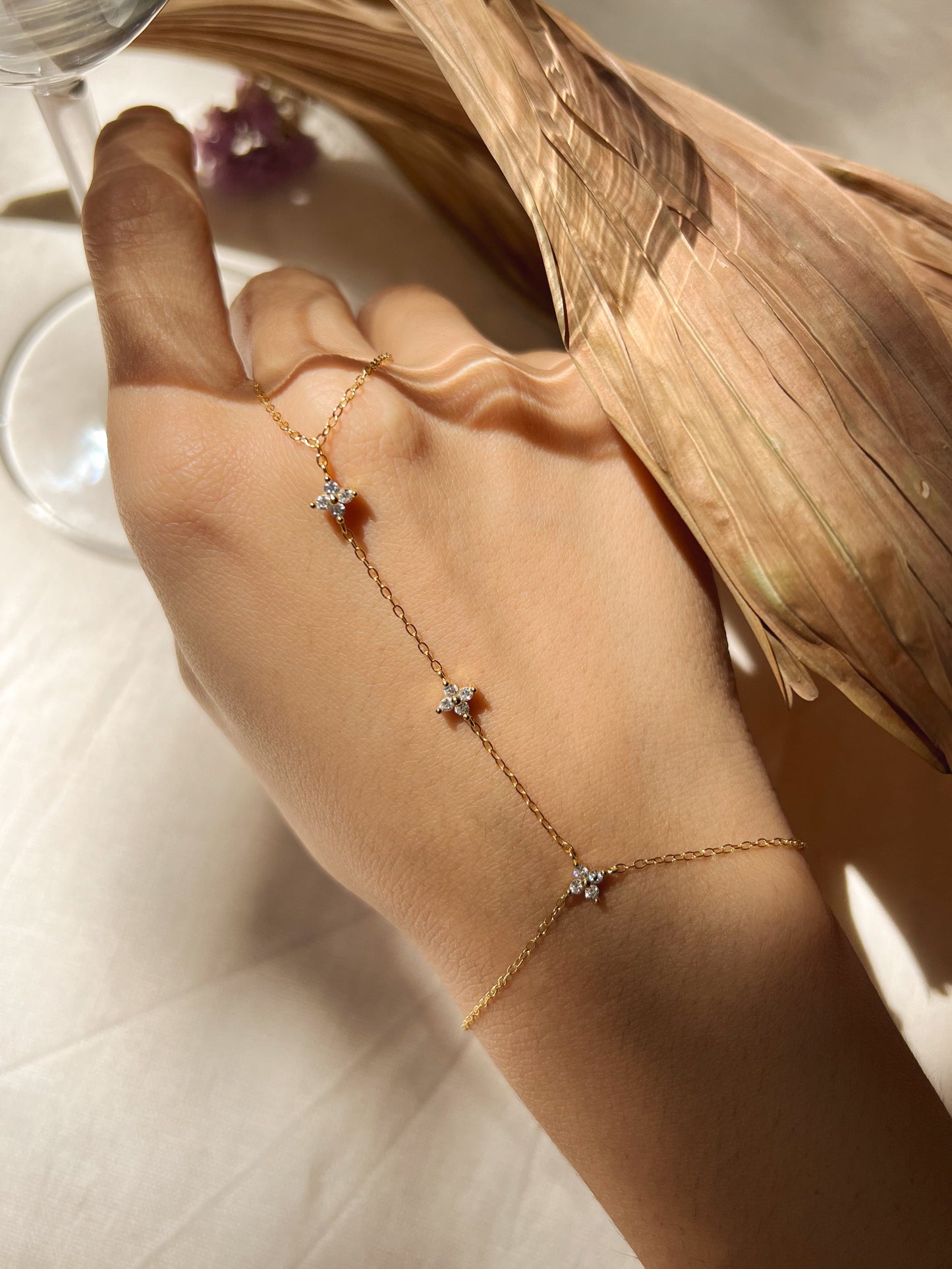 Tristar 18k gold plated hand chain with studded zircon in sterling silver