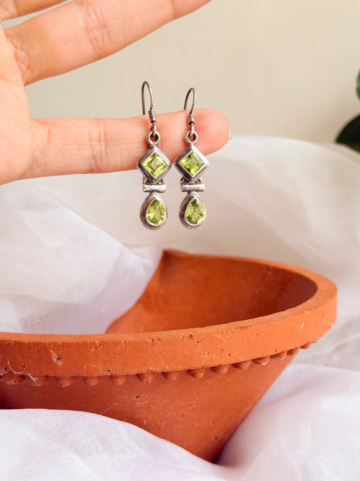 Kamya silver fish hook earrings in green peridot