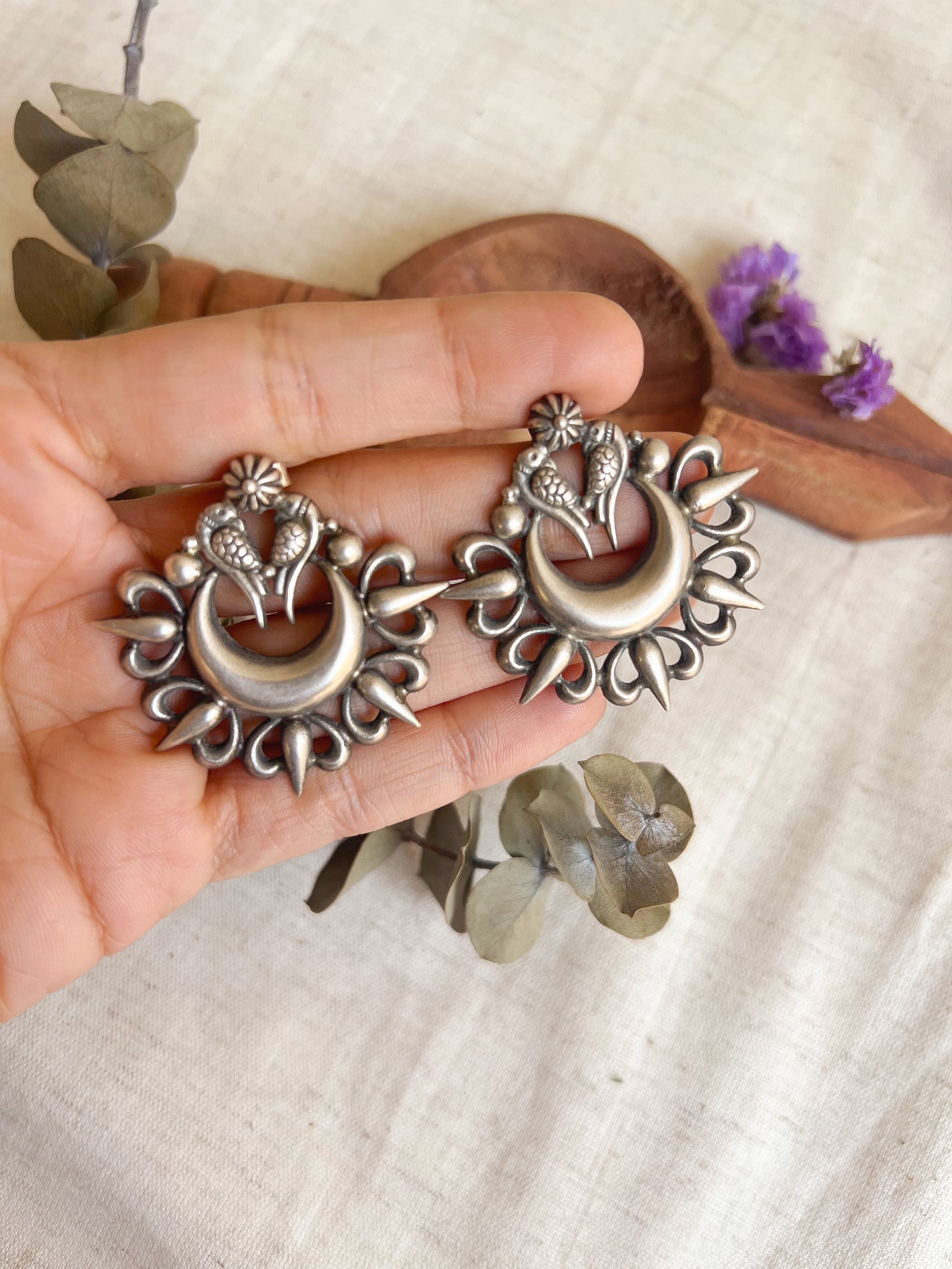 Oorja studs in oxidised silver with tota maina motif