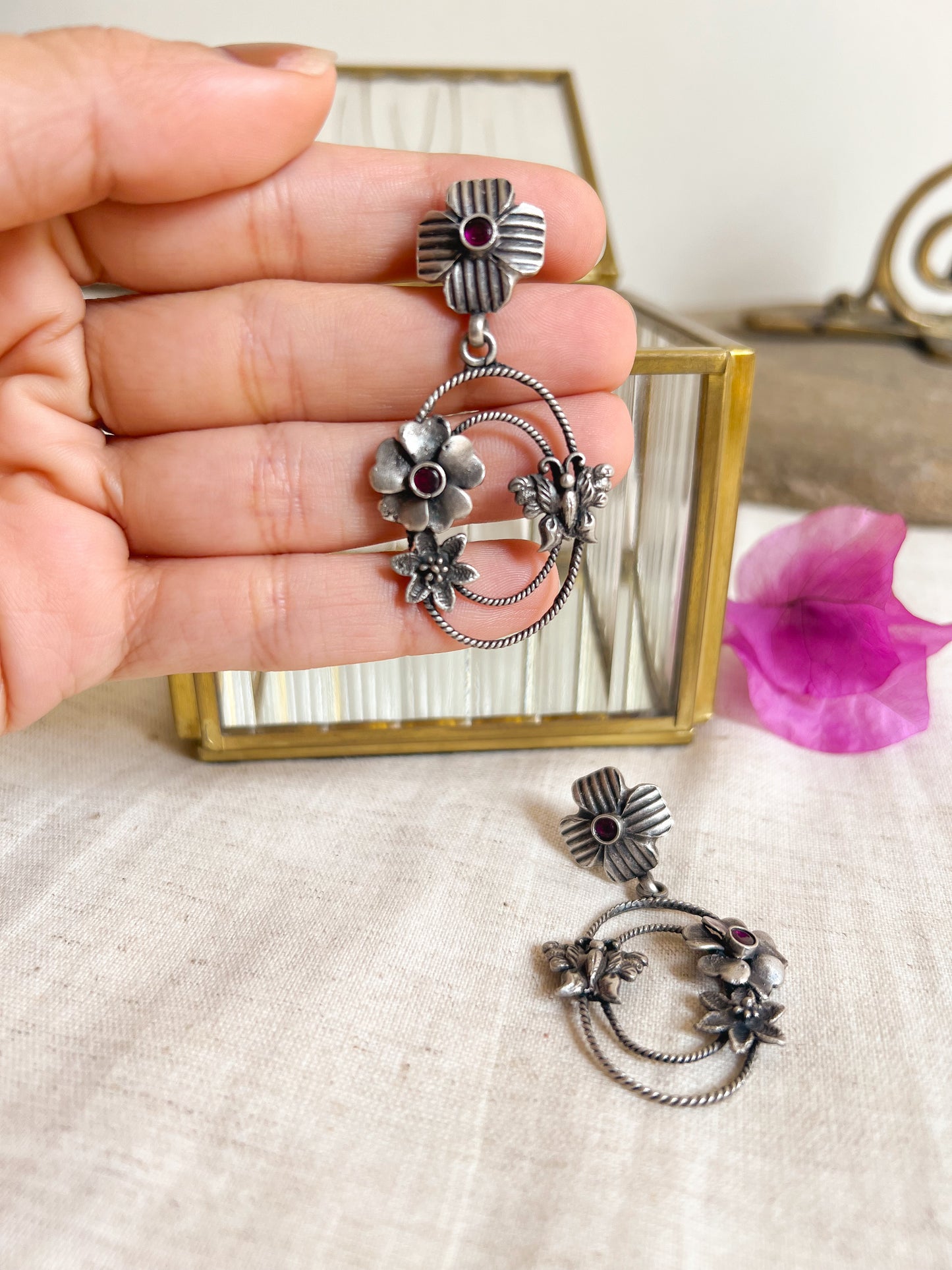 Prakruti silver earring with flower motif and ruby stone