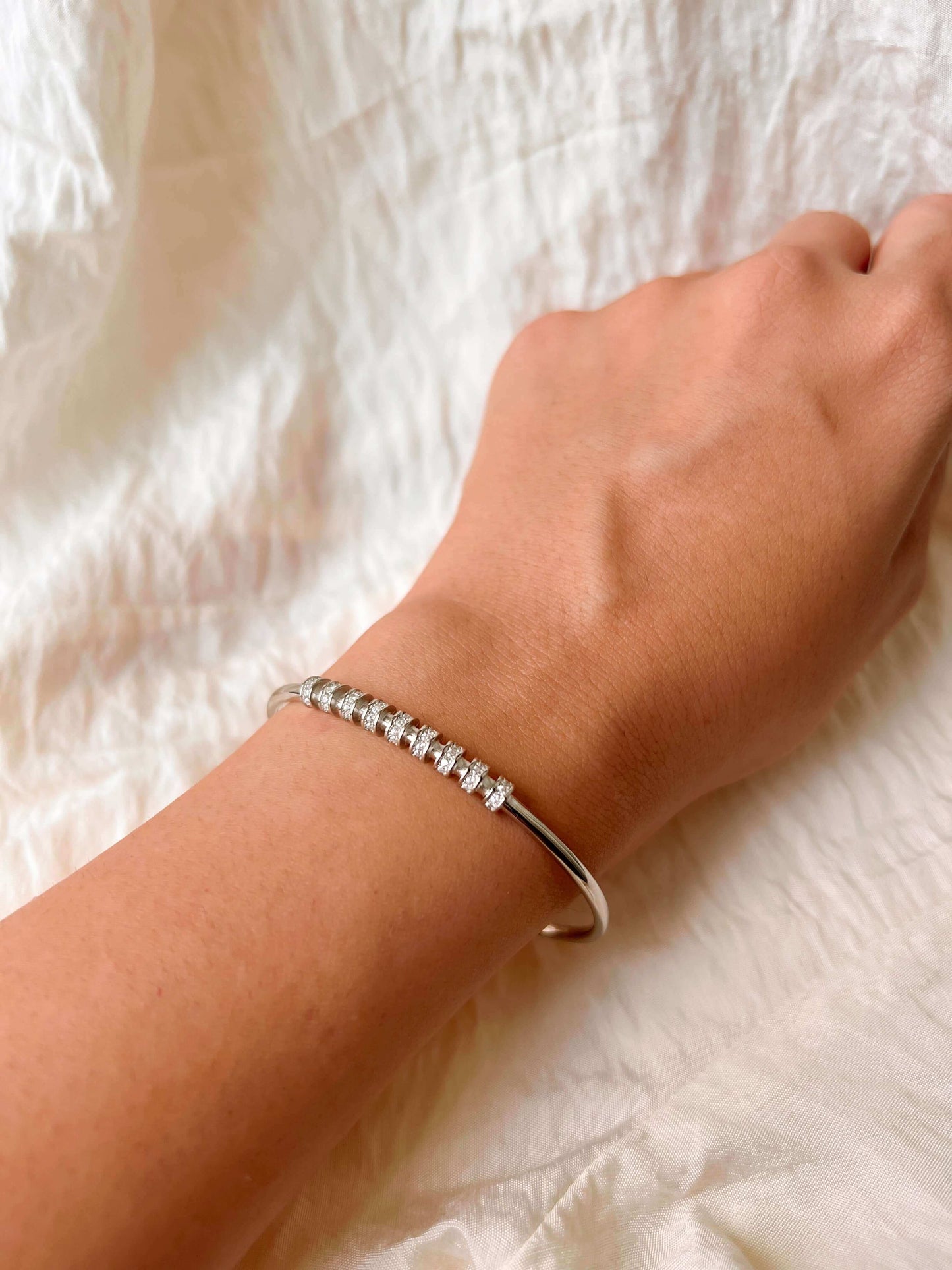 Twisty bracelet cuff in silver with zirconia